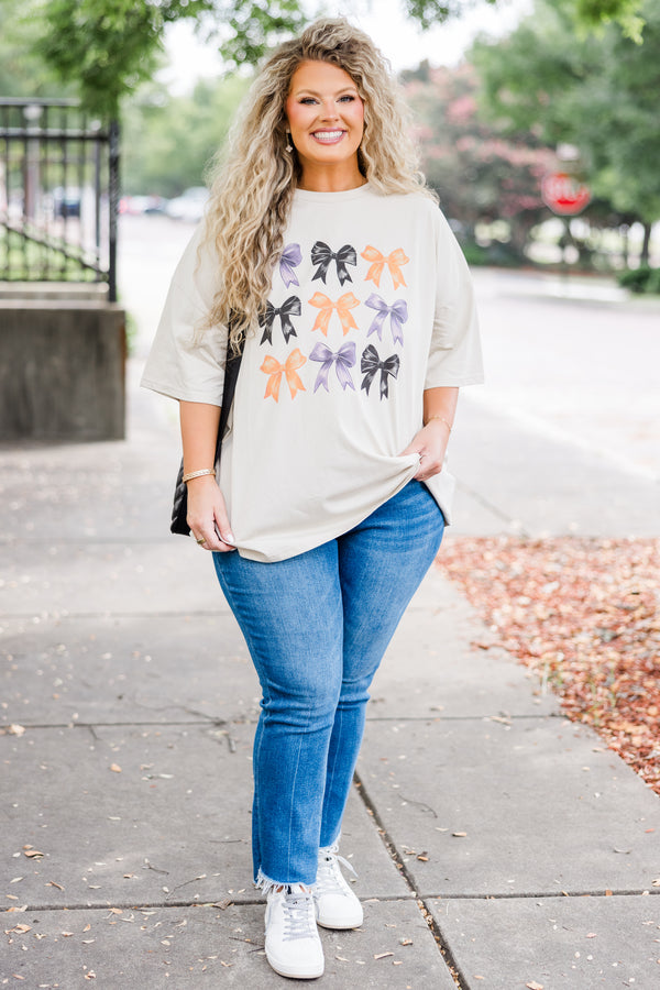 Chic Soul plus size clothing, short-sleeve dust tan graphic boyfriend tee with purple, black, and orange assorted bow graphic art 