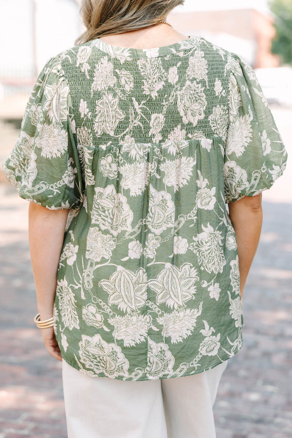 Plus Size green floral print top with elastic puff sleeves, split v-neck, and smocked shoulders.
