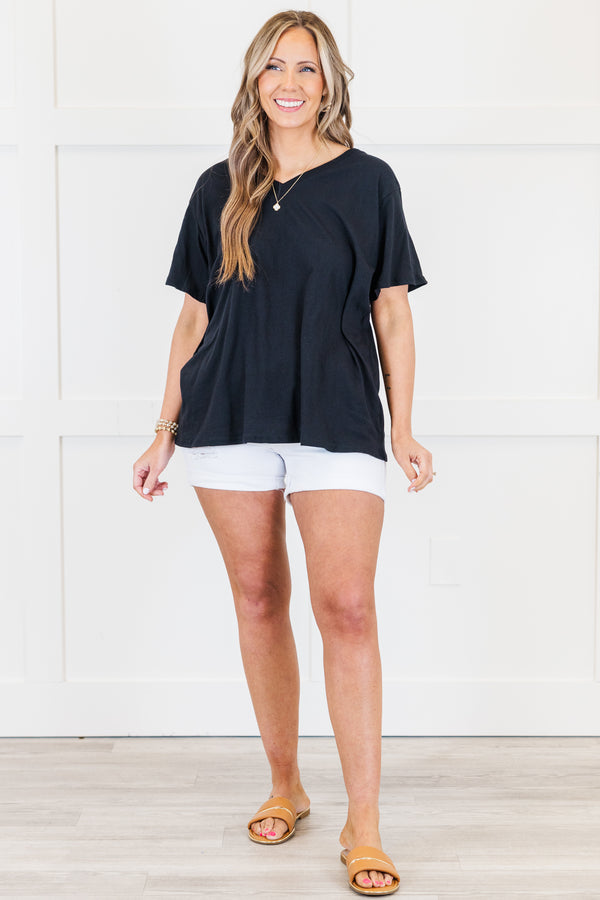 Plus Size black v-neck short sleeve cotton tee paired with white denim shorts.