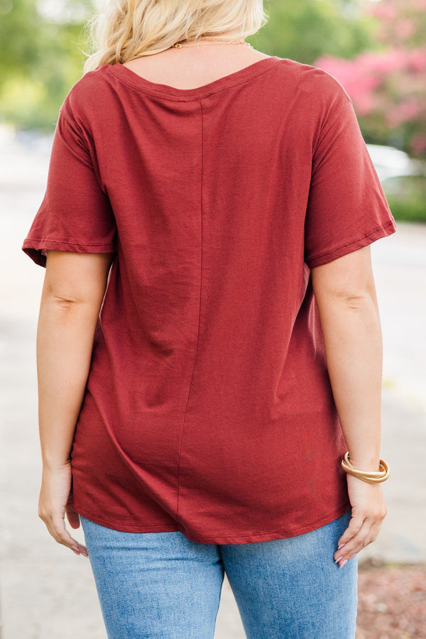 Plus Size dark rust short sleeve v-neck cotton tee paired with light wash denim jeans.