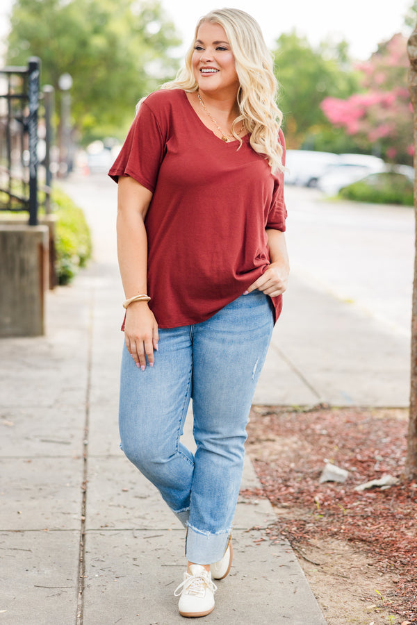Plus Size dark rust short sleeve v-neck cotton tee paired with light wash denim jeans.