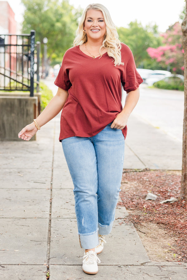 Plus Size dark rust short sleeve v-neck cotton tee paired with light wash denim jeans.