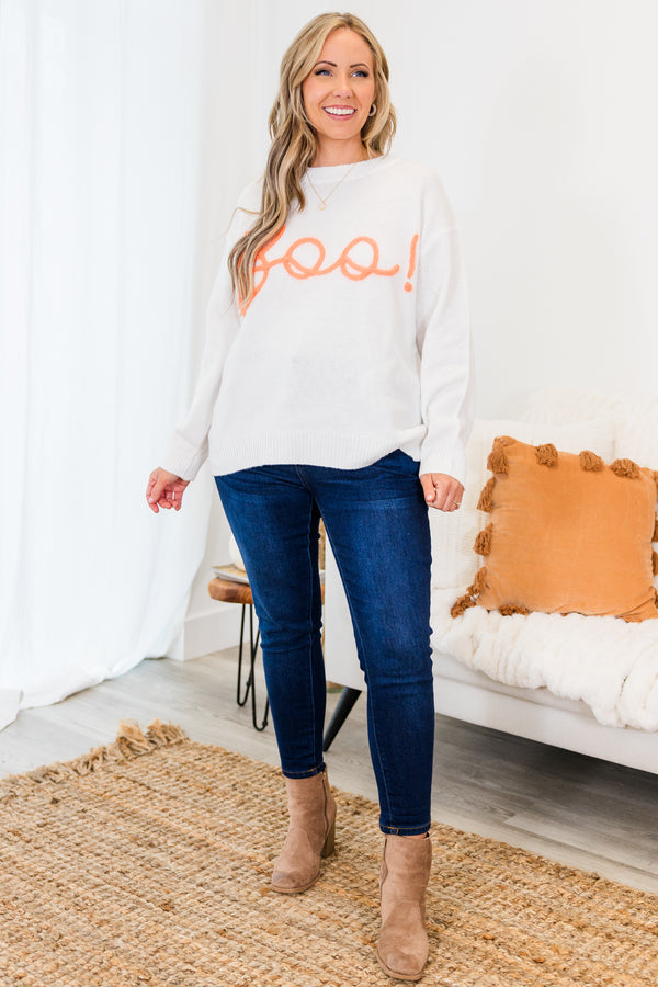 Chic Soul plus size clothing, long-sleeve crewneck white sweater with orange embroidery in cursive stating 