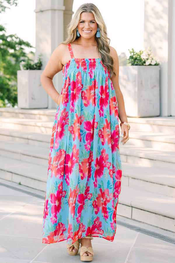 Plus Size tropical floral print maxi dress in light blue with pink and orange flowers.