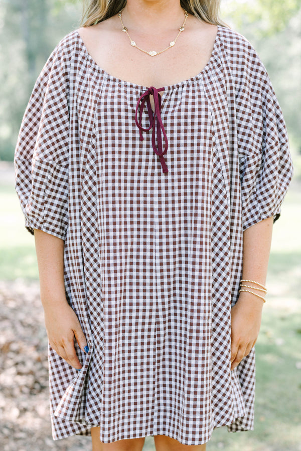Plus Size brown and white gingham cotton dress with puff sleeves and a tie-front neckline.