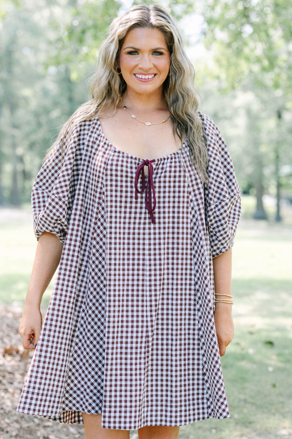 Plus Size brown and white gingham cotton dress with puff sleeves and a tie-front neckline.