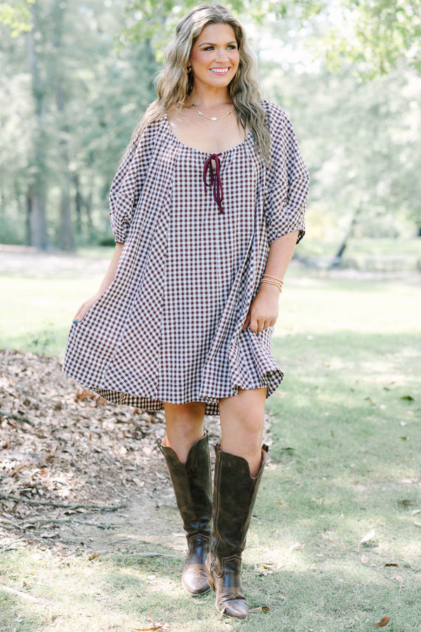 Plus Size brown and white gingham cotton dress with puff sleeves and a tie-front neckline.