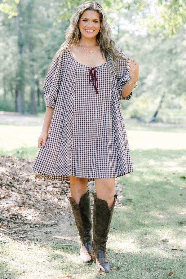 Plus Size brown and white gingham cotton dress with puff sleeves and a tie-front neckline.
