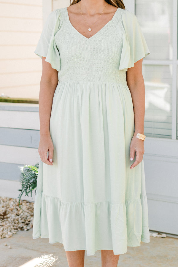 Plus Size sage green midi dress with a smocked bodice, flutter sleeves, and a tiered ruffle hem.