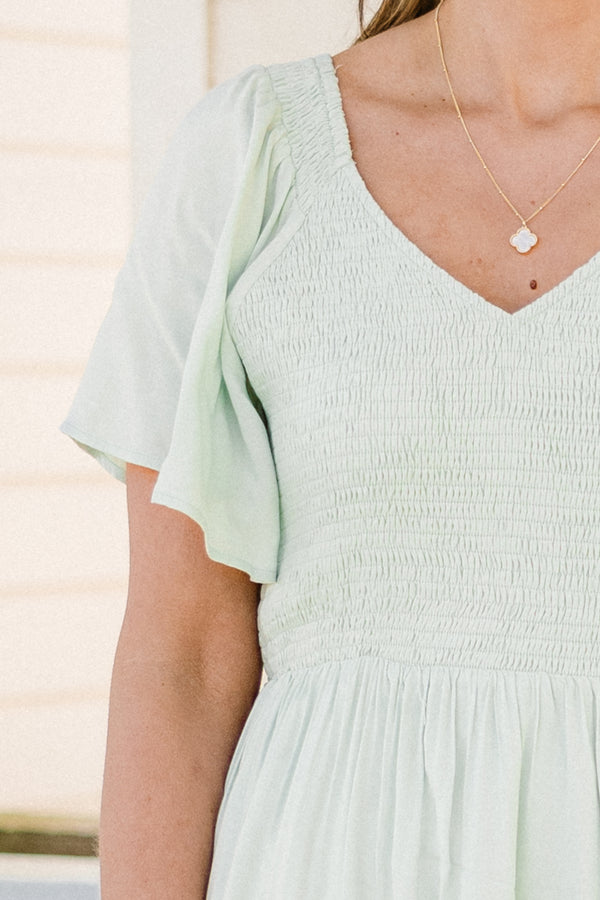 Plus Size sage green midi dress with a smocked bodice, flutter sleeves, and a tiered ruffle hem.