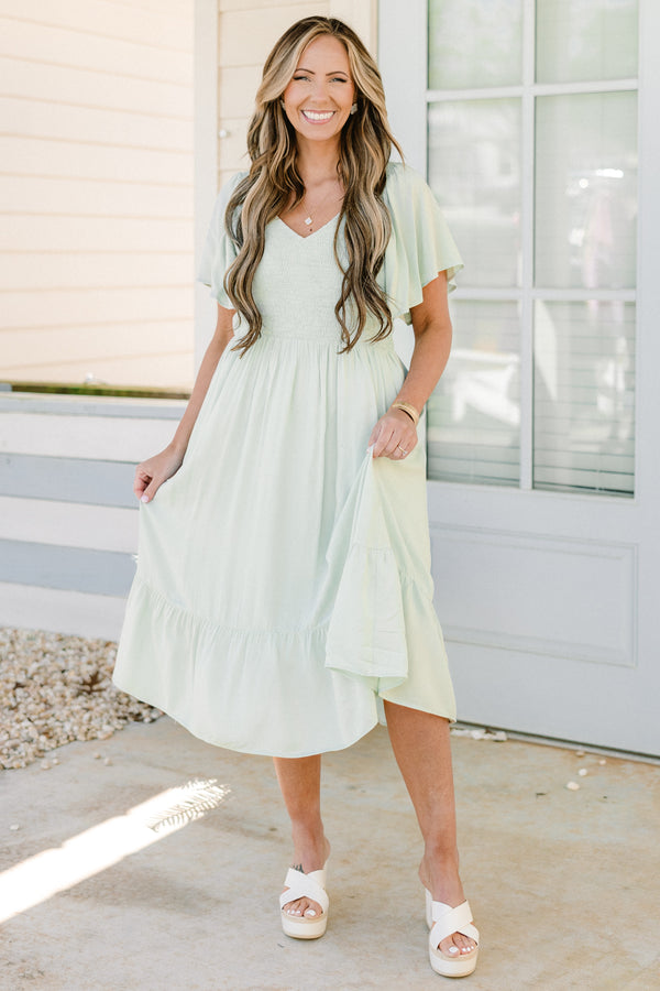 Plus Size sage green midi dress with a smocked bodice, flutter sleeves, and a tiered ruffle hem.