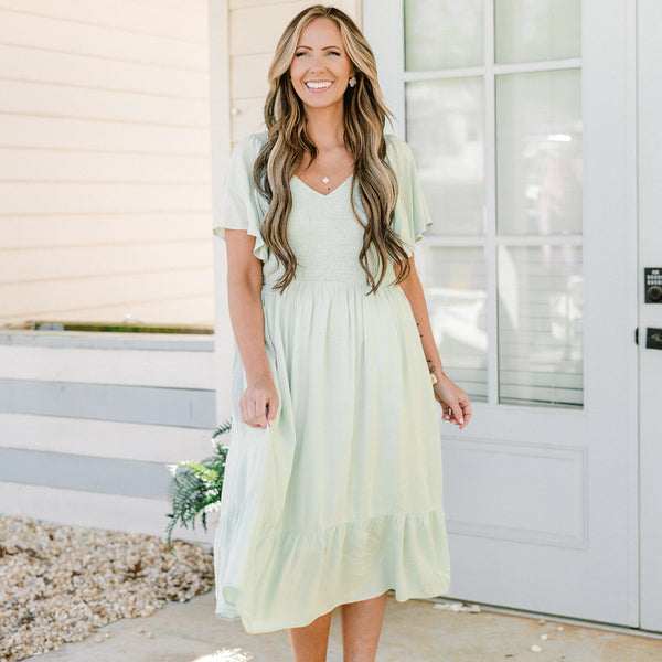 Plus Size sage green midi dress with a smocked bodice, flutter sleeves, and a tiered ruffle hem.