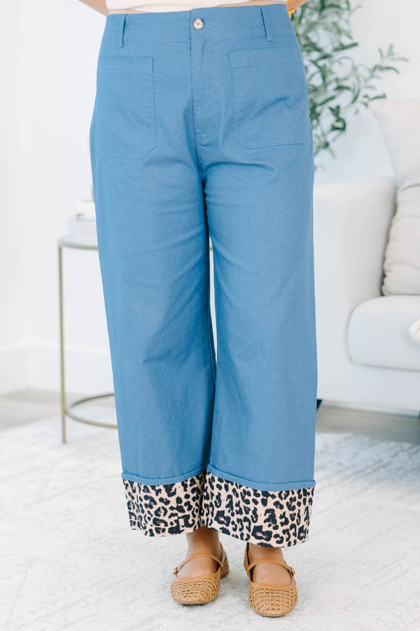 Plus size denim cropped pants with a wide leg fit and bold leopard print cuffed ankles.