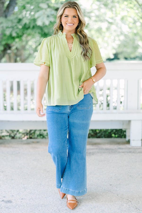 Plus Size light green textured top with a ruffled V-neckline, short flutter sleeves, and lace trim.
