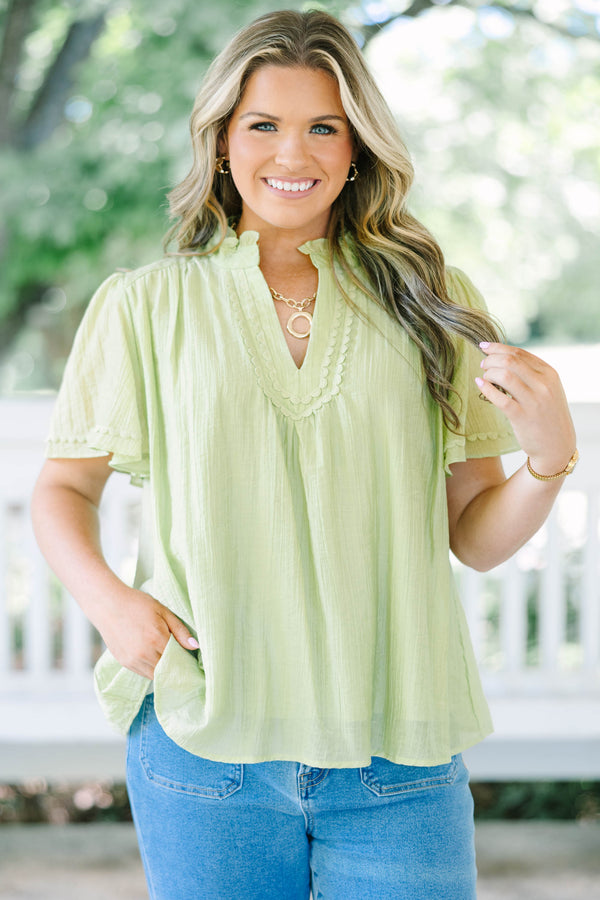Plus Size light green textured top with a ruffled V-neckline, short flutter sleeves, and lace trim.