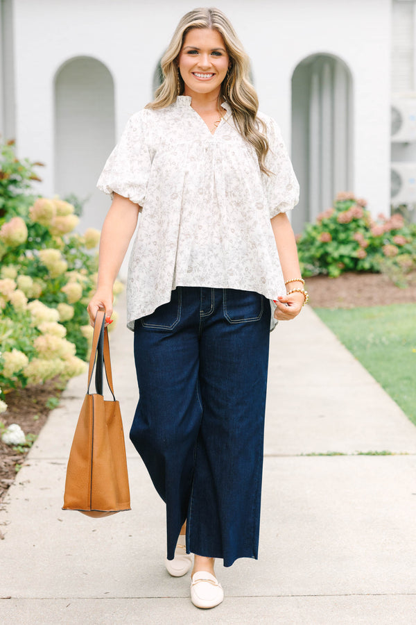 Plus Size cream floral blouse with a ruffled v-neckline and short elastic bubble sleeves.