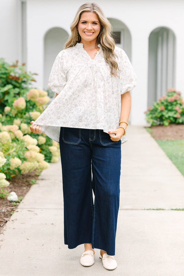 Plus Size cream floral blouse with a ruffled v-neckline and short elastic bubble sleeves.
