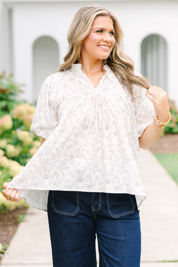 Plus Size cream floral blouse with a ruffled v-neckline and short elastic bubble sleeves.