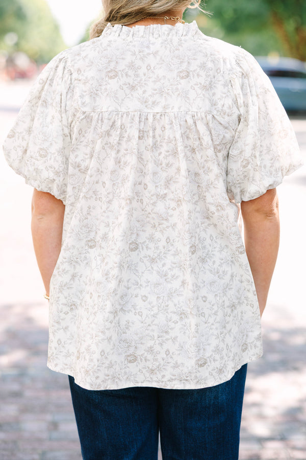 Plus Size cream floral blouse with a ruffled v-neckline and short elastic bubble sleeves.