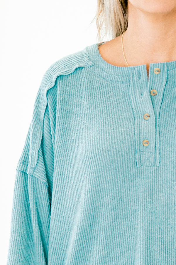 Chic Soul Plus size clothing, teal sweater with long bubble sleeves buttons going down the neckline and stitching details on the sleeves and bottom of the sweater 

