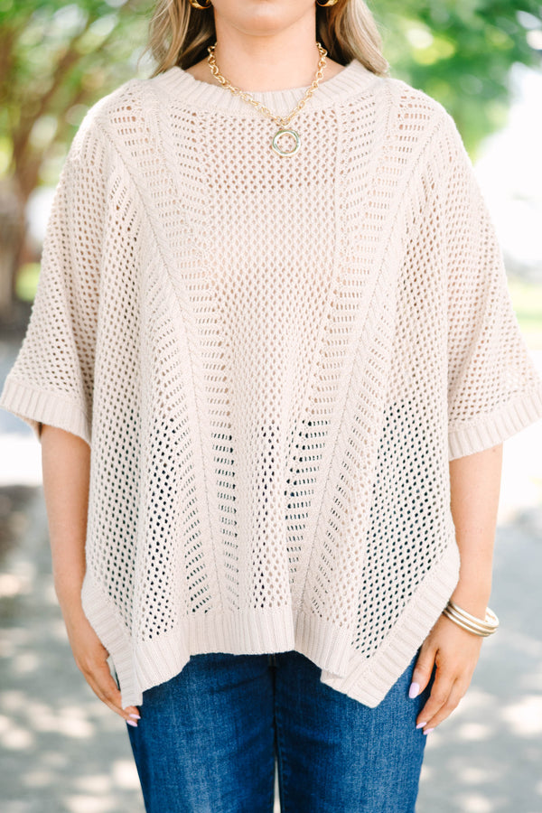 Plus size flowy oatmeal knit poncho sweater with a relaxed fit and textured stitch.