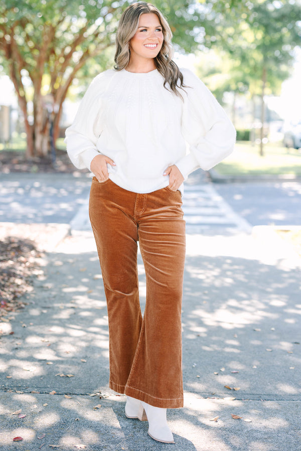 Plus size brown corduroy pants with a high-waisted, wide-leg silhouette and stretchy cotton fabric.