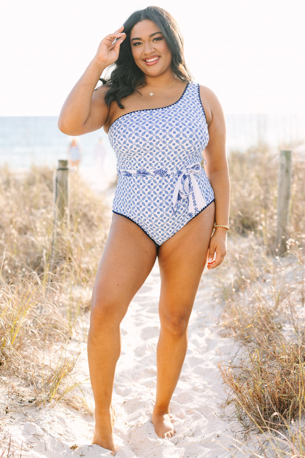 Chic Soul plus size clothing, one piece with one shoulder that has a blue abstract print and royal blue piping as well as a detachable belt that has a floral pattern  