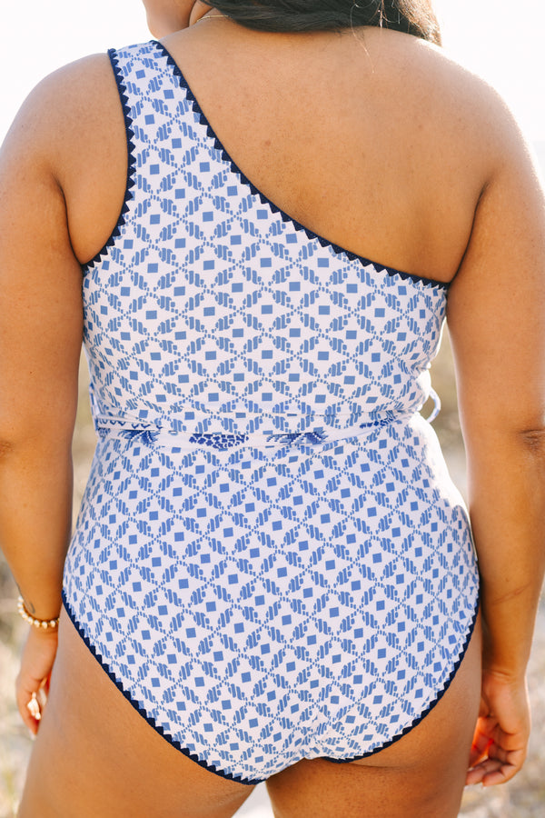 Chic Soul plus size clothing, one piece with one shoulder that has a blue abstract print and royal blue piping as well as a detachable belt that has a floral pattern  