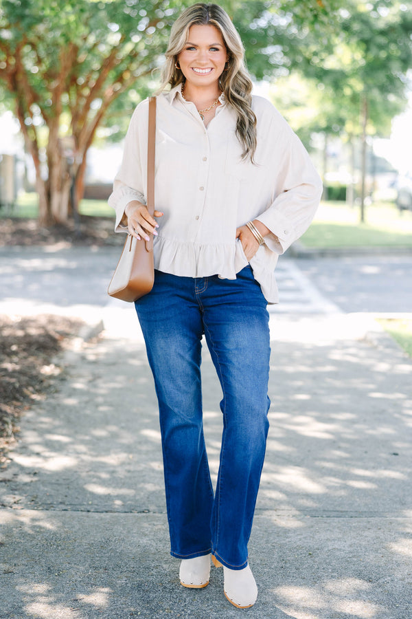Plus Size dark wash flare jeans with a high-waisted fit and subtle fading on the thighs.