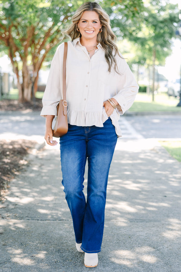 Plus Size dark wash flare jeans with a high-waisted fit and subtle fading on the thighs.