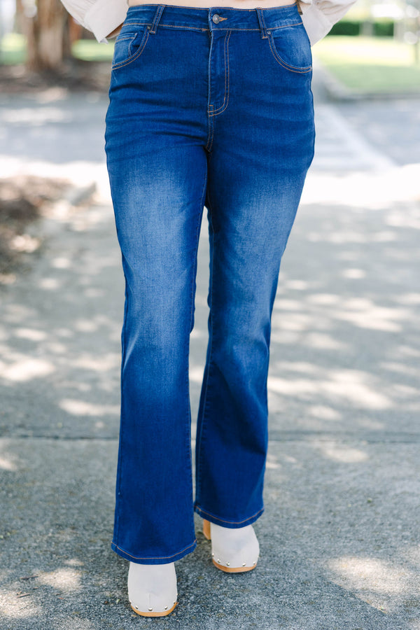 Plus Size dark wash flare jeans with a high-waisted fit and subtle fading on the thighs.