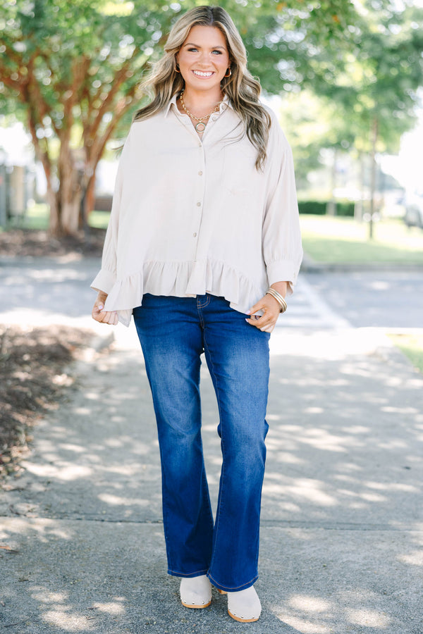 Plus Size dark wash flare jeans with a high-waisted fit and subtle fading on the thighs.