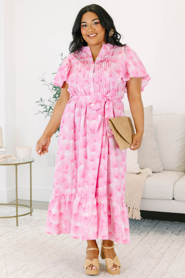 Plus size pink floral midi dress with ruffle sleeves, a tie waist, and flowy tiered skirt.