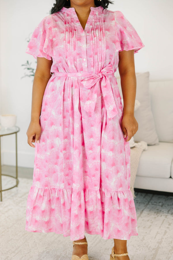 Plus size pink floral midi dress with ruffle sleeves, a tie waist, and flowy tiered skirt.