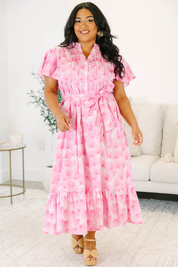 Plus size pink floral midi dress with ruffle sleeves, a tie waist, and flowy tiered skirt.