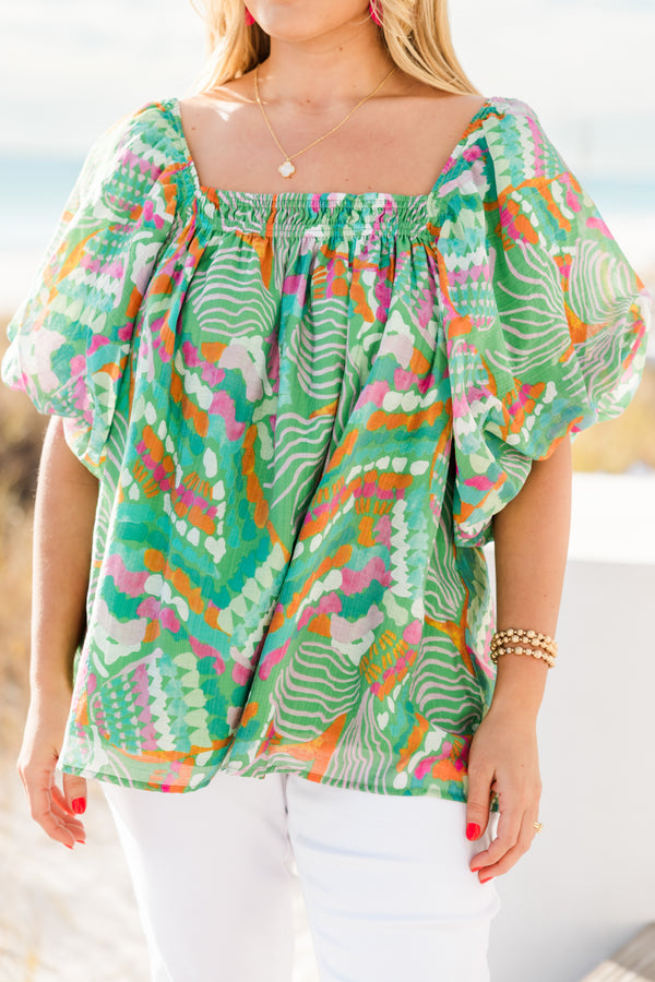 Chic Soul plus size clothing, short sleeve green tropical multicolored abstract print top with v neckline and smock detail on chest with flowy flutter sleeves