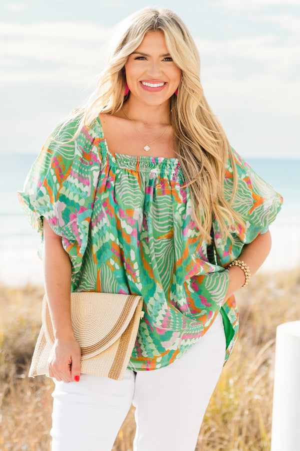 Chic Soul plus size clothing, short sleeve green tropical multicolored abstract print top with v neckline and smock detail on chest with flowy flutter sleeves