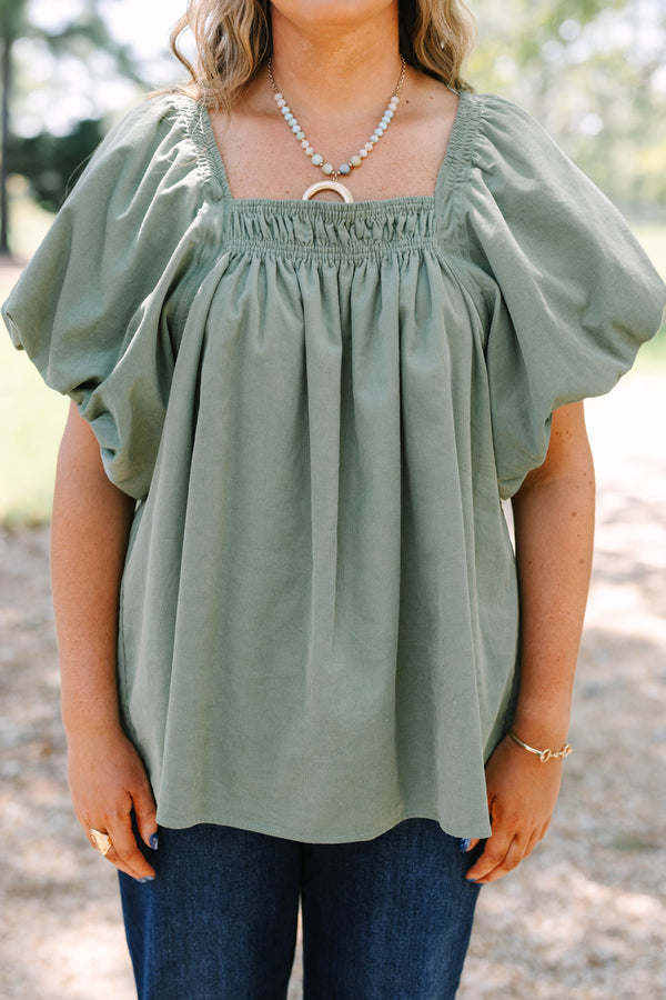 Plus size olive corduroy blouse with puff sleeves and a flowy fit.