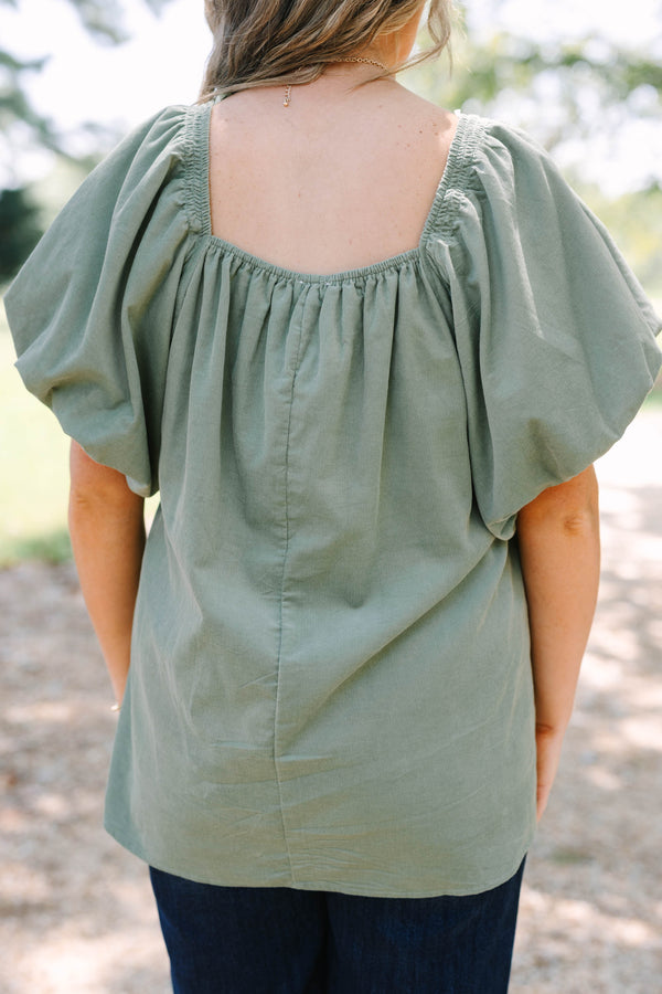 Plus size olive corduroy blouse with puff sleeves and a flowy fit.
