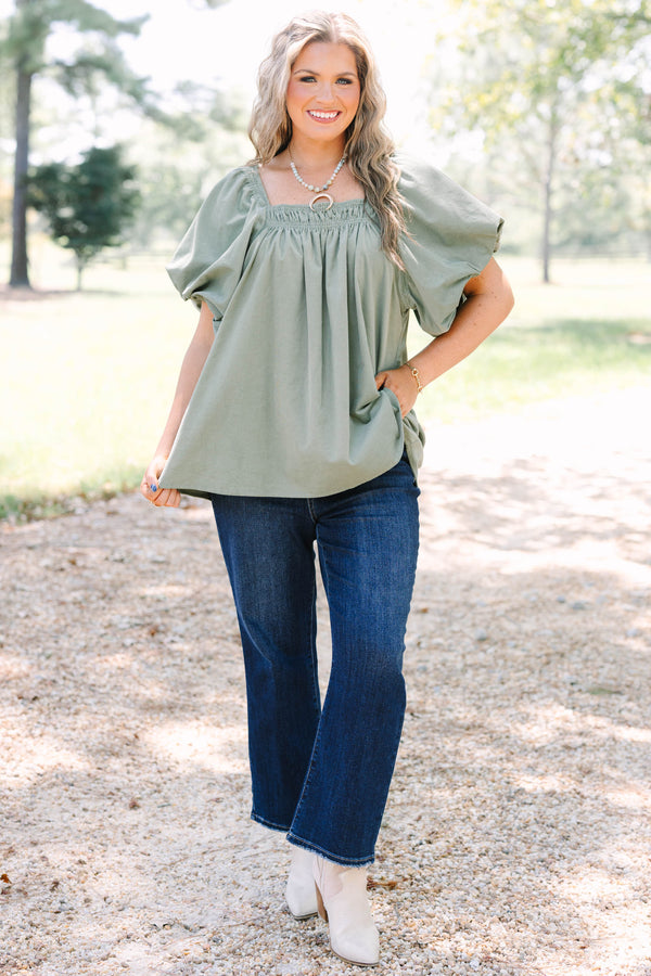 Plus size olive corduroy blouse with puff sleeves and a flowy fit.