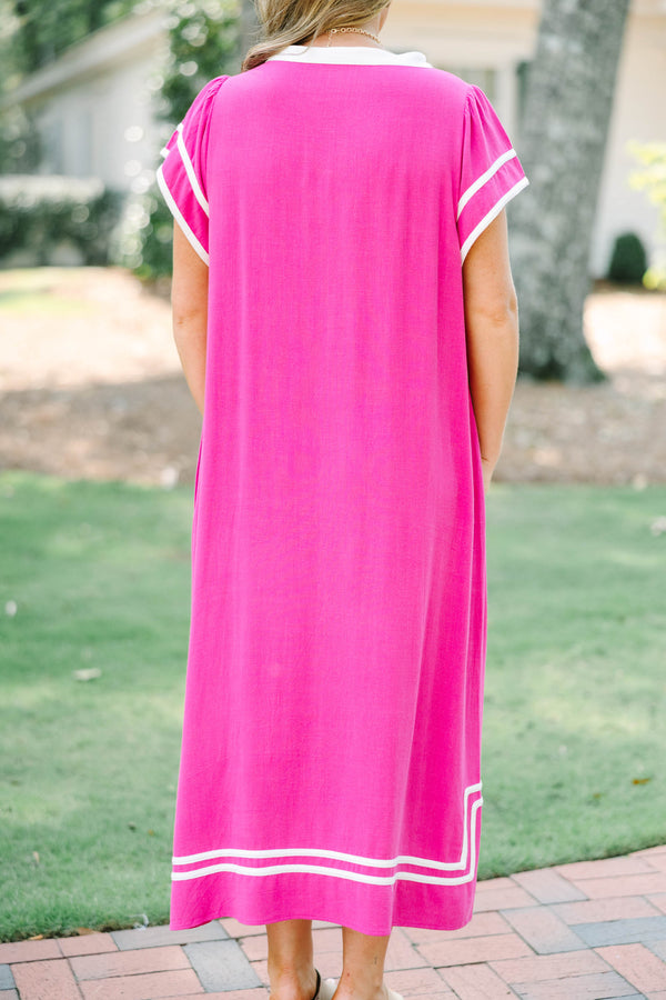 Plus size pink maxi dress with white trim, V-neckline, and flowy short sleeves.