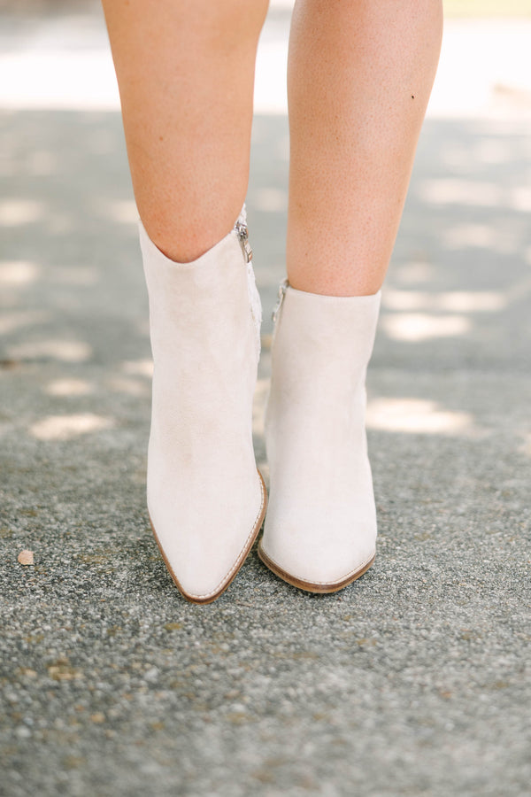 Plus Size beige pointed-toe booties with a block heel and floral daisy embroidery on the back.
