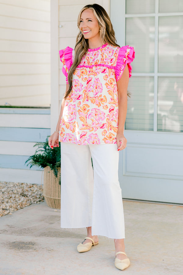 Chic Soul plus size clothing, pink and orange top with a paisley pattern as we as flutter sleeves that have pink ruffle detail on the ends of the sleeves 
