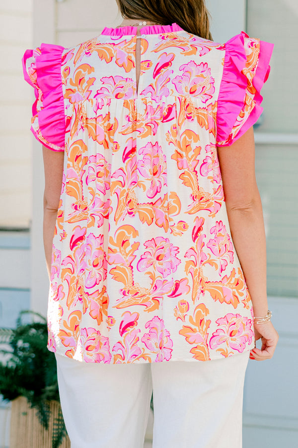 Chic Soul plus size clothing, pink and orange top with a paisley pattern as we as flutter sleeves that have pink ruffle detail on the ends of the sleeves 
