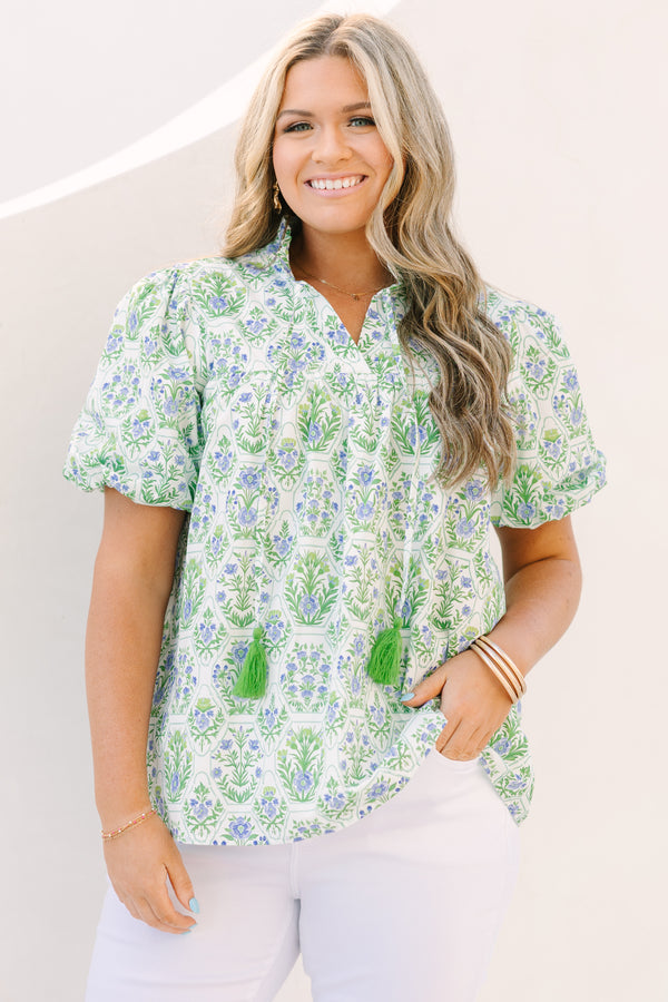 Chic Soul plus size clothing, green top with bubbles that has a multi colored floral block pattern and two tassels hanging from the ruffle collar 
