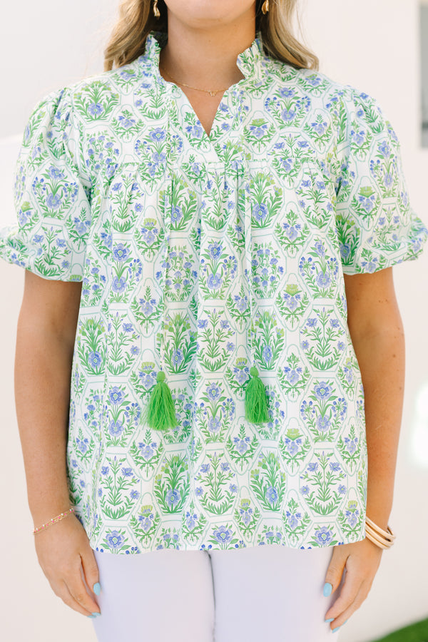 Chic Soul plus size clothing, green top with bubbles that has a multi colored floral block pattern and two tassels hanging from the ruffle collar 
