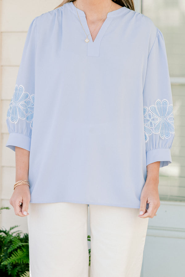 Chic Soul plus size clothing, blue three quarter length sleeve blouse with v cutout along neckline with blue/white embroidered flowers on sleeves with cuff sleeves
