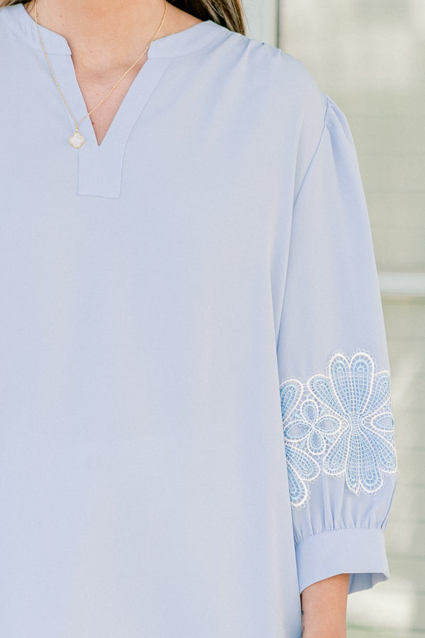 Chic Soul plus size clothing, blue three quarter length sleeve blouse with v cutout along neckline with blue/white embroidered flowers on sleeves with cuff sleeves
