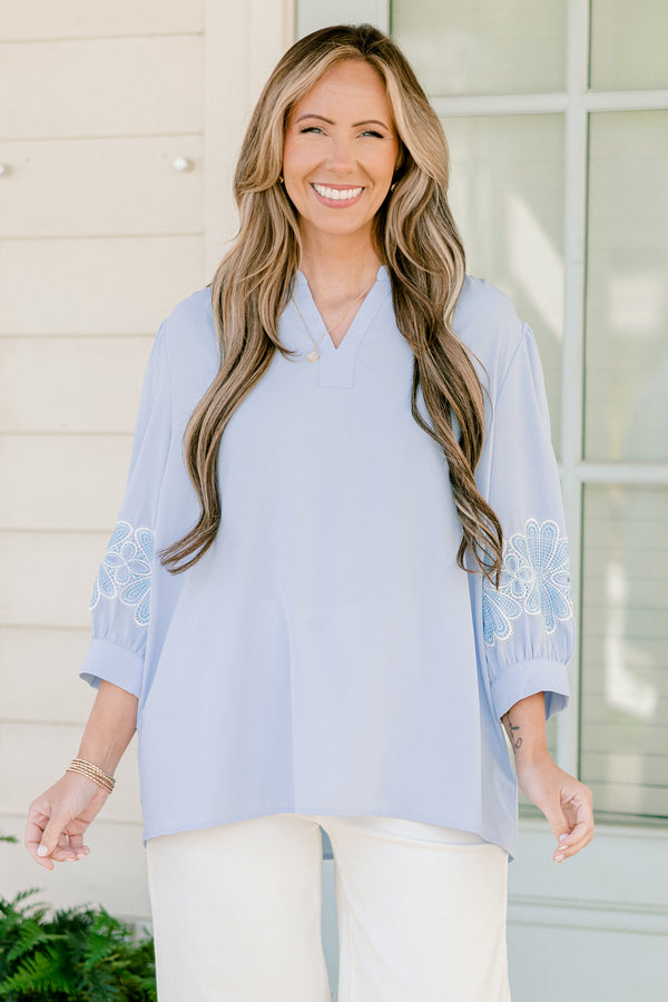 Chic Soul plus size clothing, blue three quarter length sleeve blouse with v cutout along neckline with blue/white embroidered flowers on sleeves with cuff sleeves
