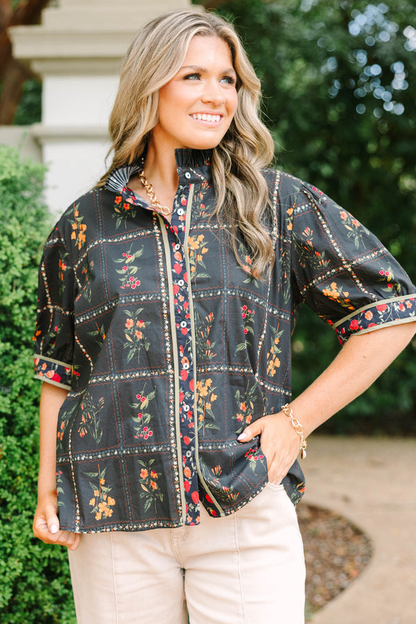 Plus size black cotton button-up top with multi-floral print, puff sleeves, and ruffled collar.